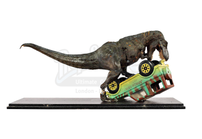 Lot #426 - JURASSIC PARK (1993) - Phil Tippett Collection: Tyrannosaurus Rex Stop-Motion Puppet and Jeep Model Miniature Display